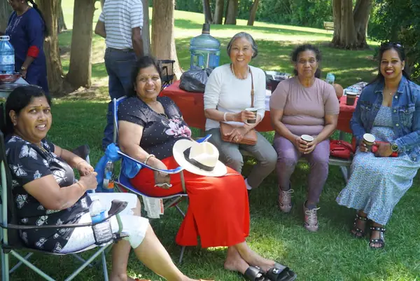 People relaxing in lawn chairs on the grass