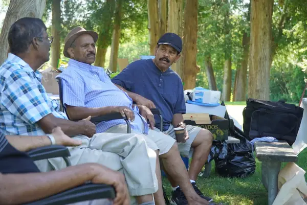 People seated and chatting in a park