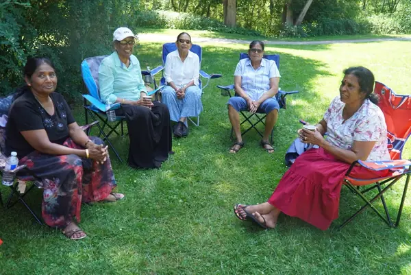 People relaxing in lawn chairs on the grass