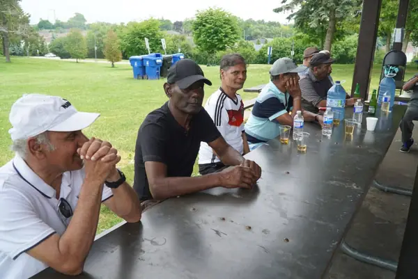 People seated at a long picnic table
