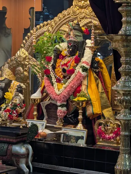 Decorated statue of a deity in a shrine