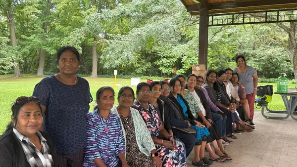 People seated together under a pavilion