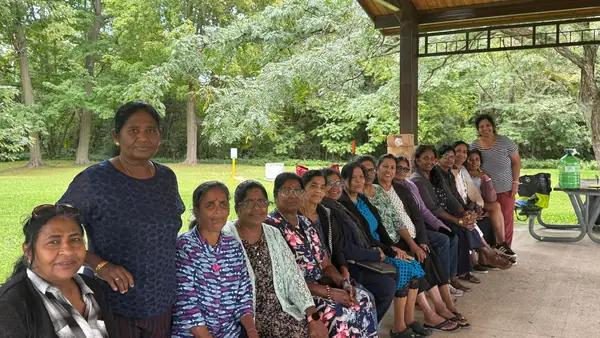 People seated together under a pavilion