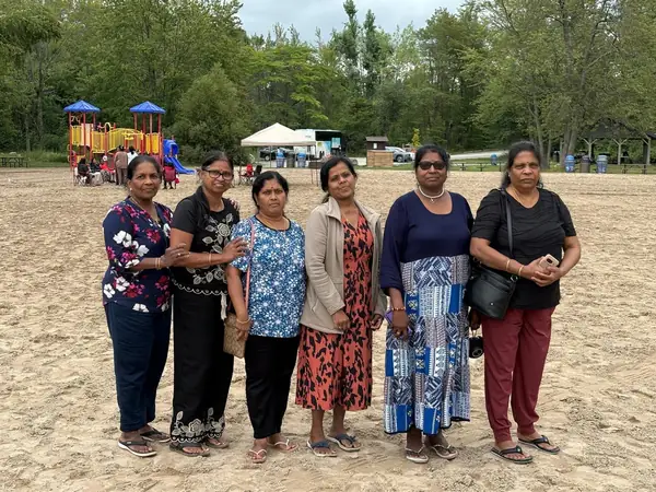 Group of women standing on a sandy beach