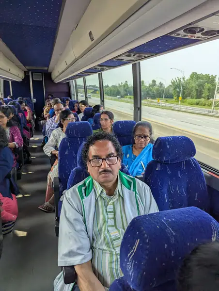 A man seated on a tour bus