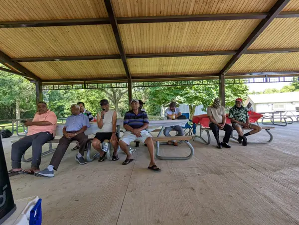 People seated under a pavilion