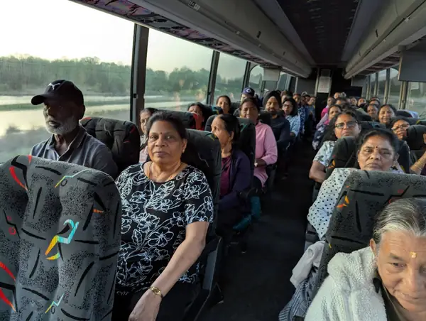 People seated on a tour bus