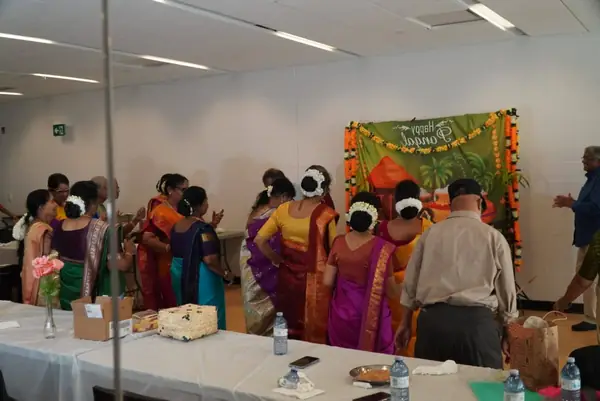 Women in saris performing indoors