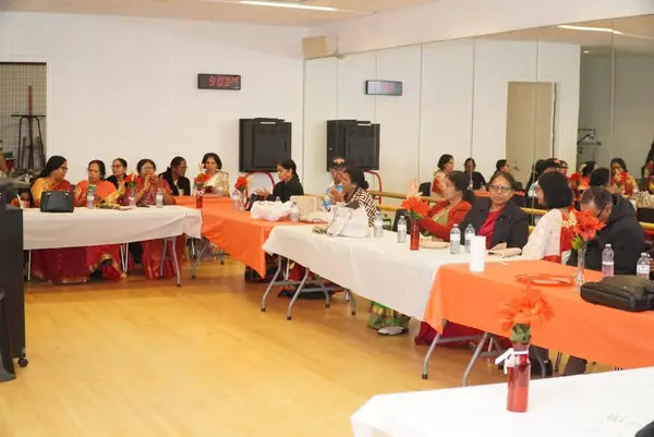 Hall set up with tables and orange tablecloths