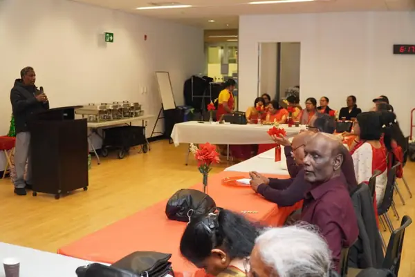 People seated at tables in a hall