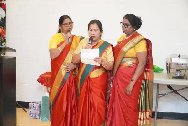 Women in saris singing together