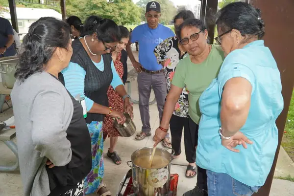People gathered around a table outdoors