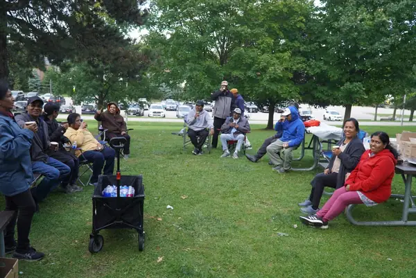 People seated in lawn chairs on the grass