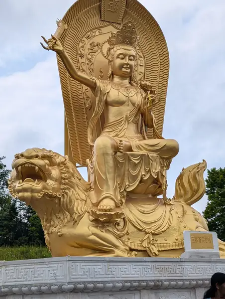 Golden statue of a figure riding a lion