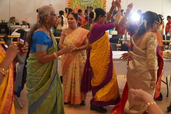 Women in saris dancing together