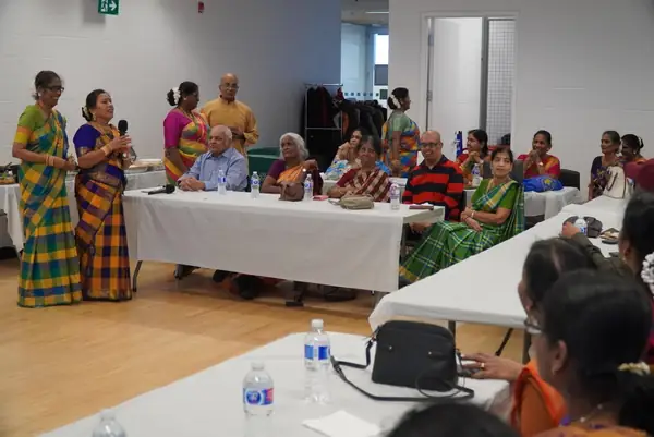 People seated at tables in a hall